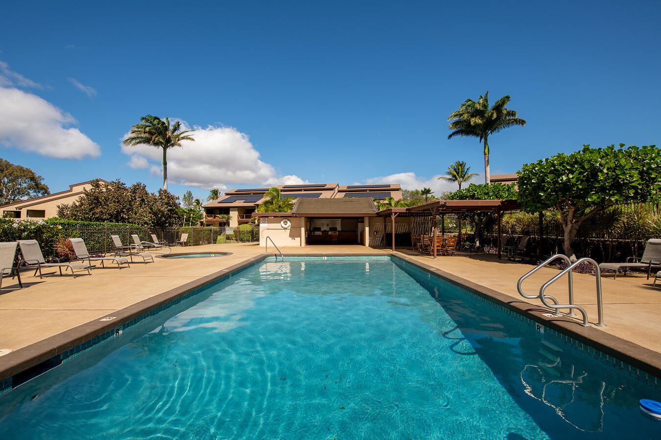 Community Pool & Pavilion — Just steps away, enjoy the community pool and hot tub. The covered pavilion is perfect for outdoor dining, featuring two free-to-use gas grills, a sink, a refrigerator, and a shaded dining area.